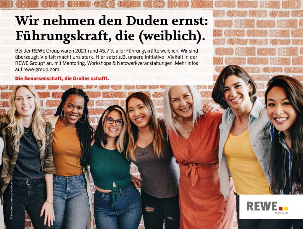 Eine Gruppe von Frauen stehen vor einer Ziegelwand.
