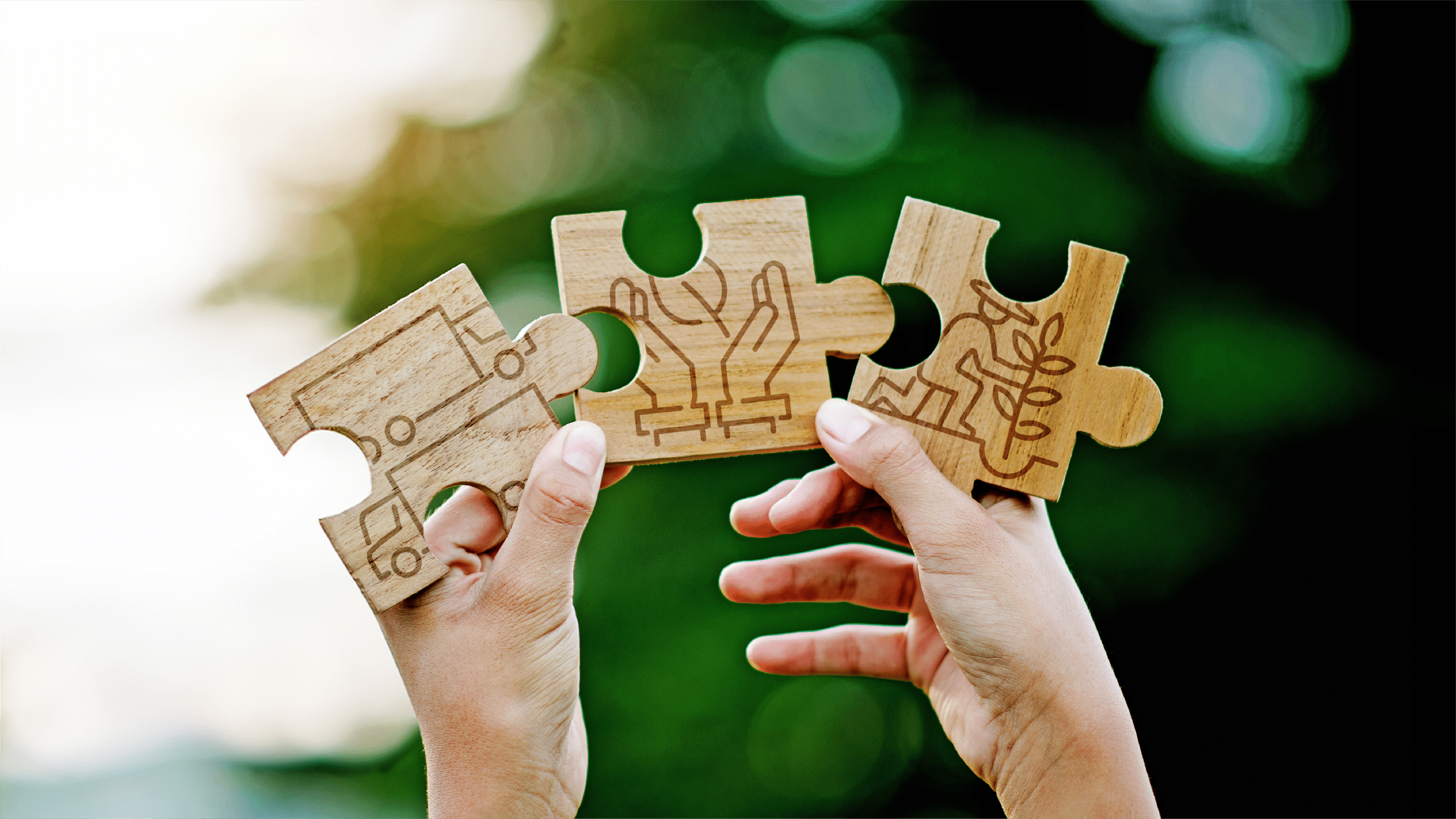Puzzelteile mit Symbolen für Lieferwagen, Händen und einem Menschen der eine Pflanze einpflanzt